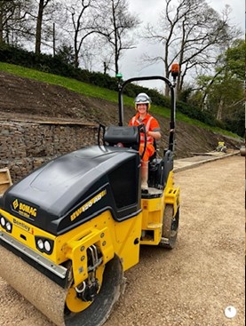 A construction worker driving a roller