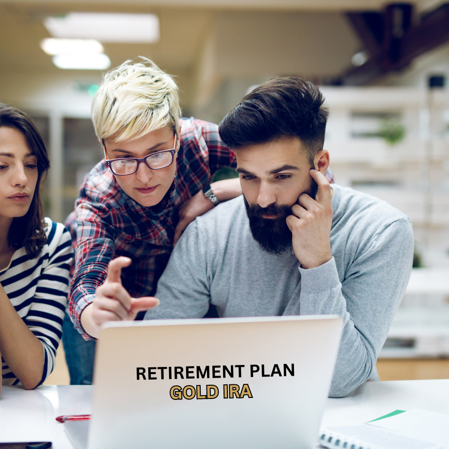 3 people looking at a laptop labelled "Retirement plan. Gold IRA". A lady in glasses showing the male and female something ono the screen.