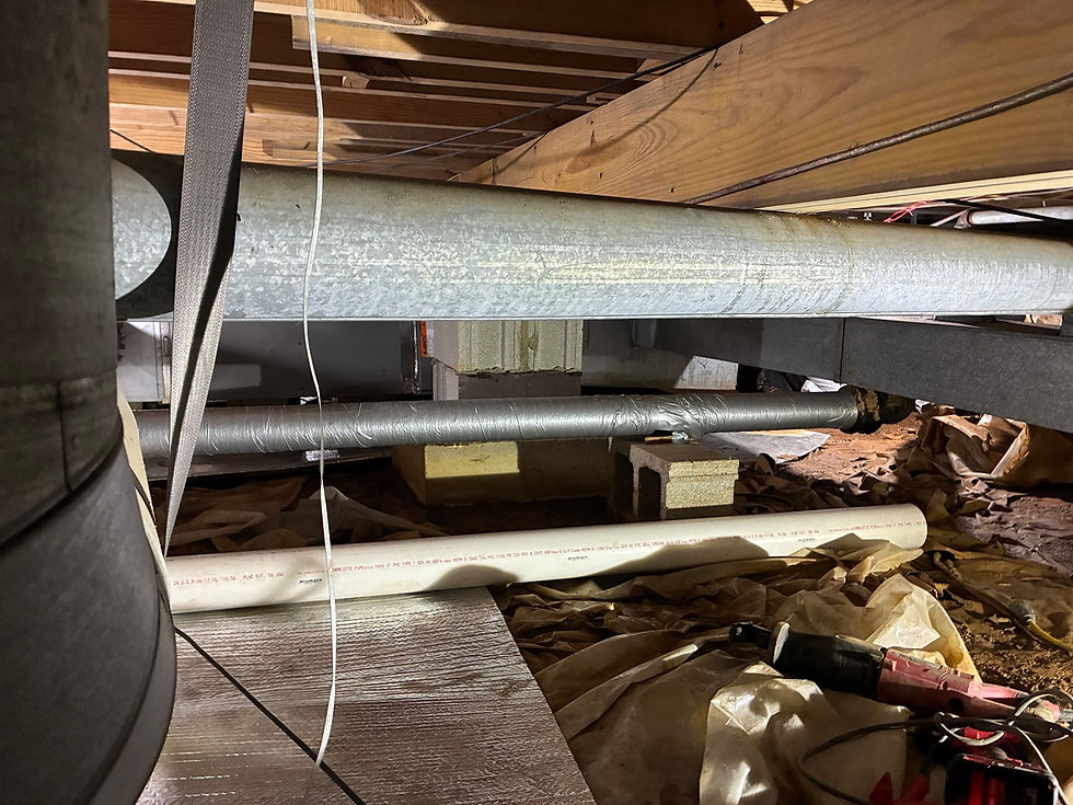 Crawlspace piping and wood framing documented during the Lexington project