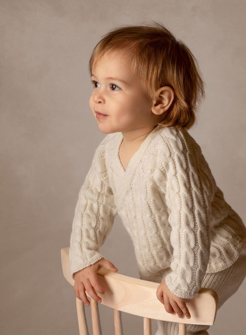 Baby standing by chair during studio session