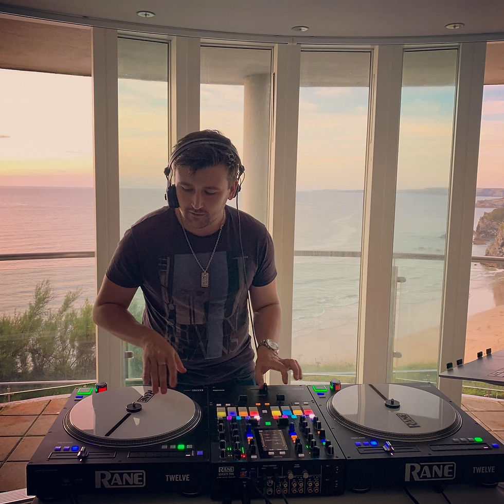 DJ playing music overlooking the ocean