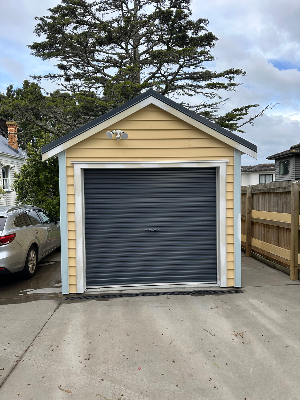 Rebuilt heritage garage with new concrete driveway and patio
