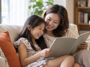 Mother and daughter enjoying a book together at home