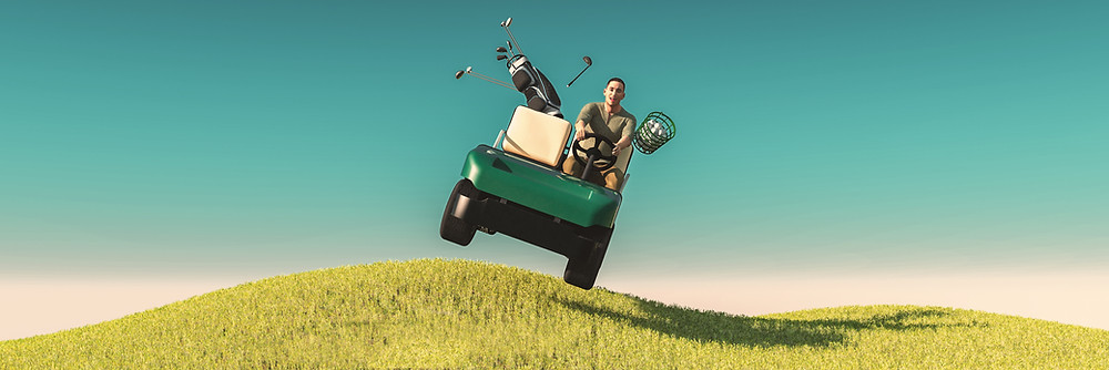 Person driving golf cart over big hill.