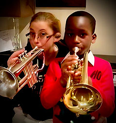 Melinda, online vocal and songwriting coach at Inspired Playing, singing and playing piano during a concert performance.