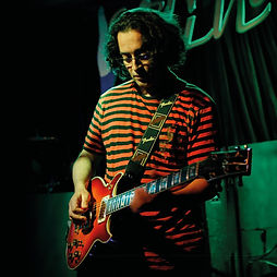 Melinda, online vocal and songwriting coach at Inspired Playing, singing and playing piano during a concert performance.