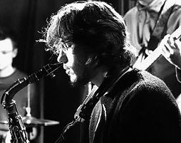 Melinda, online vocal and songwriting coach at Inspired Playing, singing and playing piano during a concert performance.