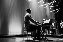 Melinda, online vocal and songwriting coach at Inspired Playing, singing and playing piano during a concert performance.