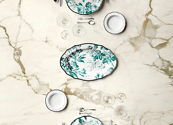 White with brown veining porcelain countertop with white and green decorative plates