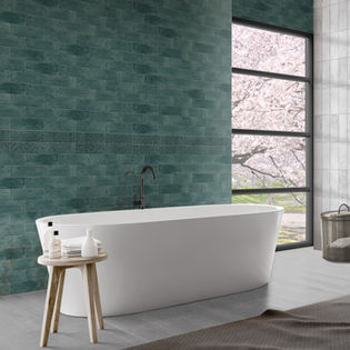 Bathroom with green tile walls & white bathtub