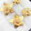 Thumbnail: Trillium Flower & Star Drop Earrings in 18k Yellow Gold 