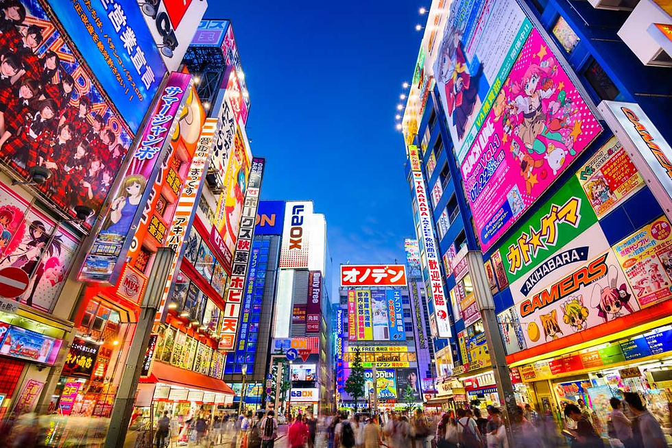 Crowded Akihabara street at dusk, glowing with colorful anime billboards and Japanese signs under a deep blue sky.