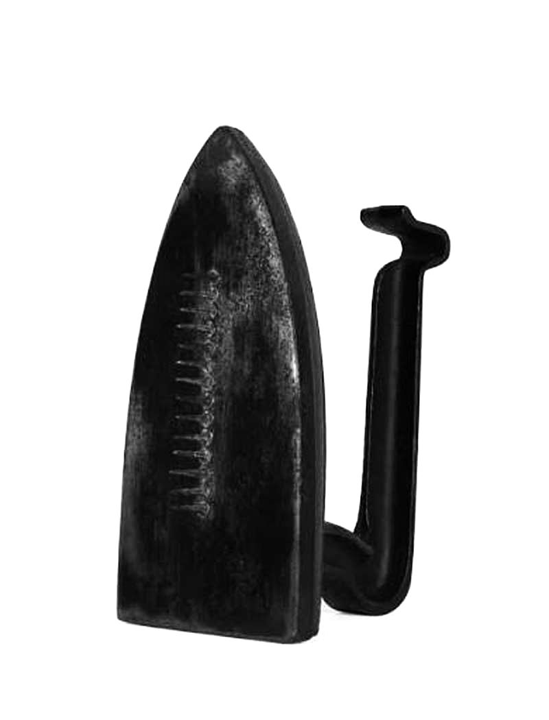 Black vintage flat iron with a curved handle on a white background, shown in close-up with a worn, matte finish.