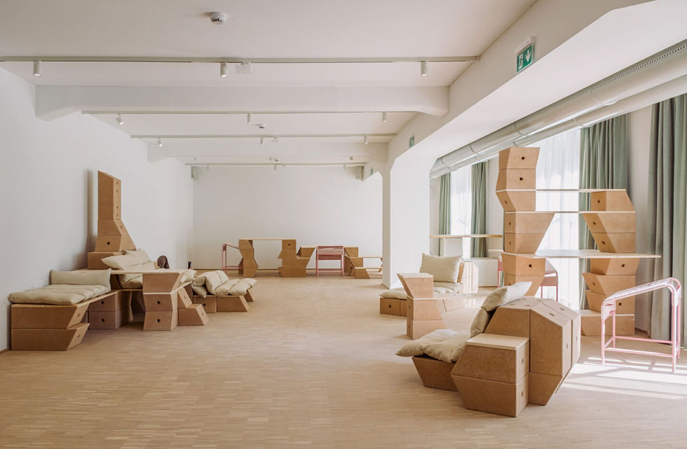 Interlocking geometric cork blocks forming a sculptural partition with hexagonal cutouts.