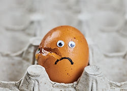 sad-broken-egg-paper-egg-tray-easter-cracked-chicken-egg-with-eyes-funny-emotion