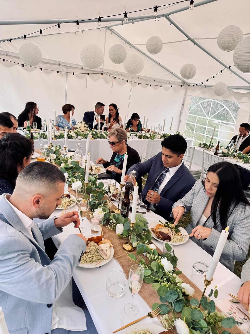 Guests seated at elegantly decorated tables under a tent during an event or wedding at a catering event by La Sazon