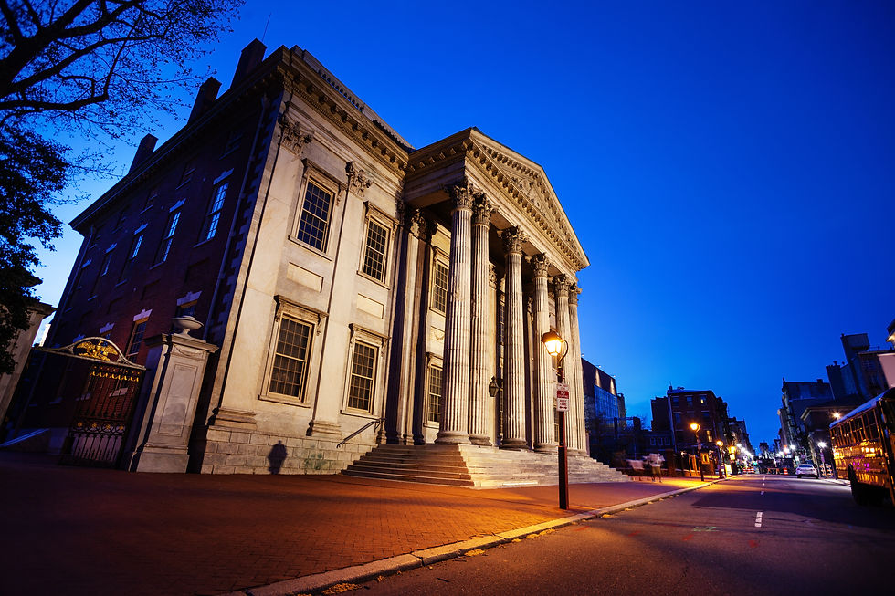 Neoclassical building with stone columns at dusk.
