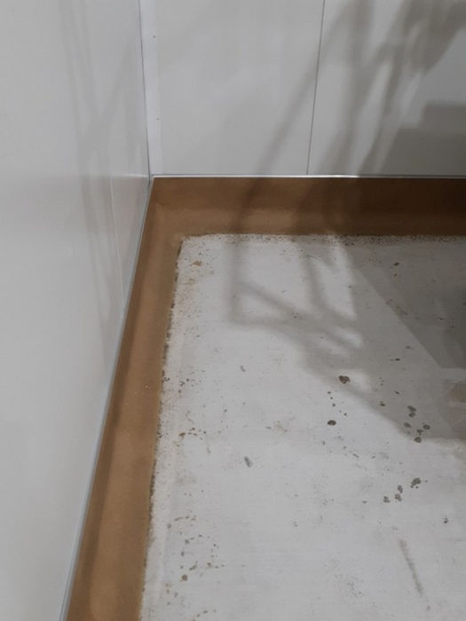 Detailed preparation of sanitary cove base for an Epoxy Flooring Installation, ensuring a seamless and easy-to-clean wall-to-floor transition.