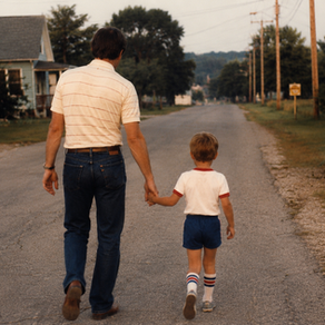 Man and boy holding hands, walking down a quiet suburban street. Red car parked nearby. Trees line the road. Peaceful, warm setting.