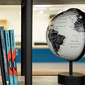 Storytelling books on a bookshelf with a plant and globe_edited.png