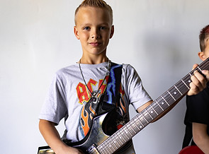 Young guitar player learning guitar at Summit School of Music