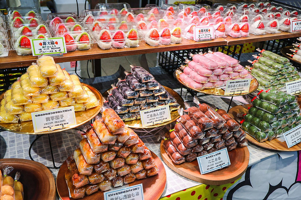 A display of Japanese sweets including dango and ichigo daifuku.