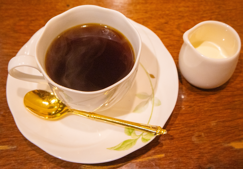 a cup of coffee and a side of cream
