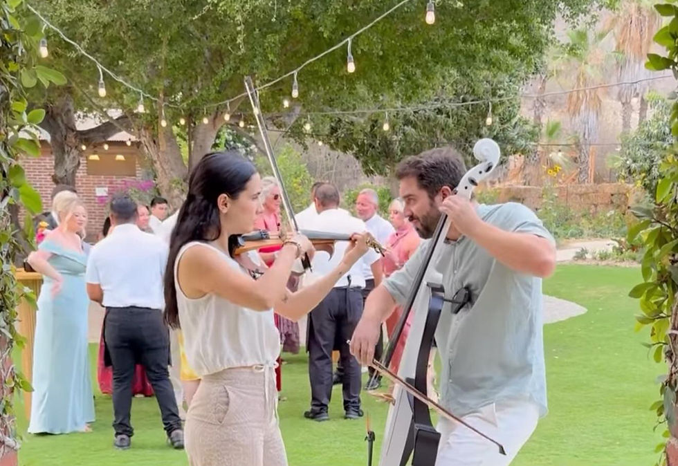 Violin and Cello duo playing at Flora Farms wedding in Los Cabos.