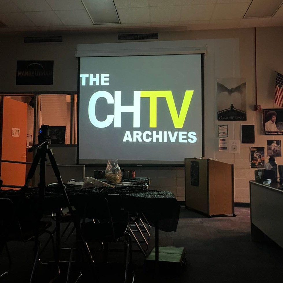 A projector screen with the CHTV opening logo on it