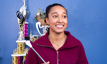 Ireland Jones sitting and holding a button while looking into the distance