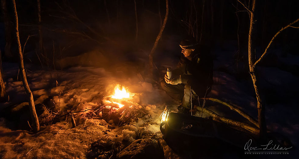 Man sitting by campfire in Finland