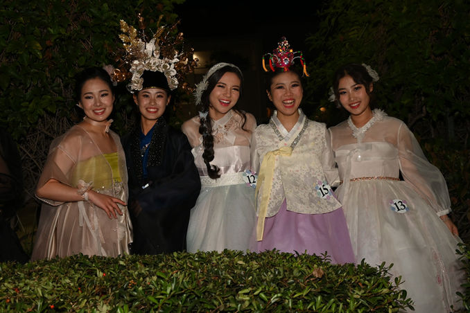 A GROUP OF FIVE 2024 HI-TEEN USA® CONTESTANTS IN TRADITIONAL KOREAN ATTIRE SMILING BEFORE THEY GO ON STAGE FOR THE HANBOK PORTION OF THE COMPETITION