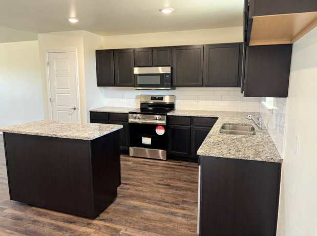 Kitchen view of Eastland Homes, highlighting thoughtful design, durable materials, and space for family gatherings.