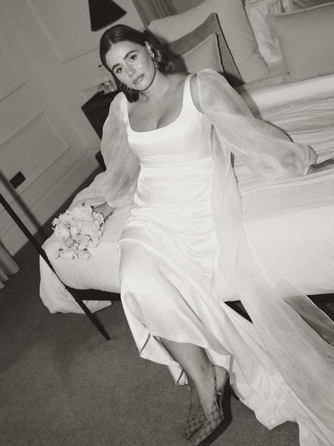 A bride sitting on a luxurious bed