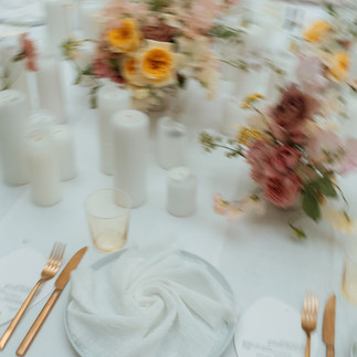 A wedding breakfast table with wedding flowers