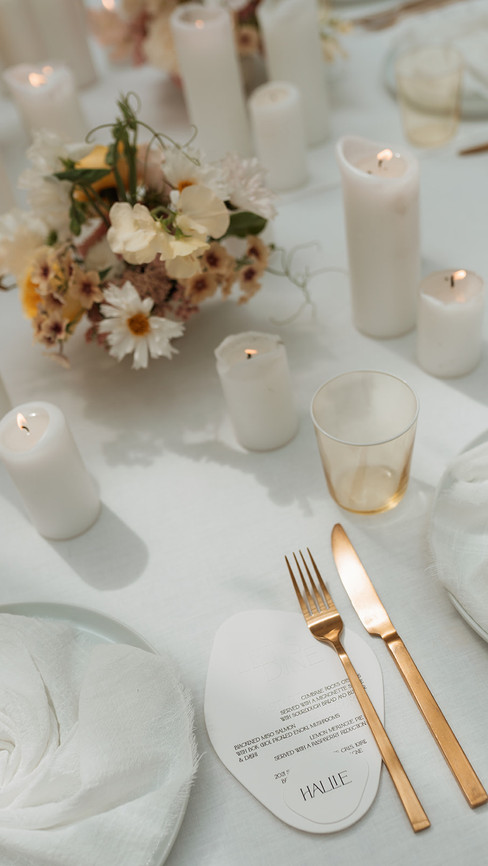 A beautiful neutral wedding table with flowers and wedding stationery