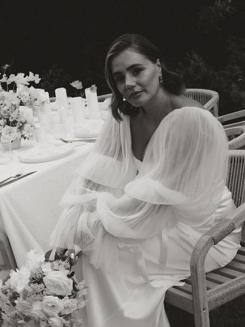 A bride by her wedding breakfast table