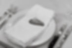 B&W photo of Agate slice keychain place card on napkin at place setting
