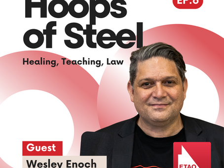 Photographic portrait of Wesley Enoch who is an Aboriginal Gen X man and is wearing a suit jacket and an Aboriginal flag t-shirt. Text reads: Hoops of Steel. Healing Teaching Law. Guest: Wesley Enoch