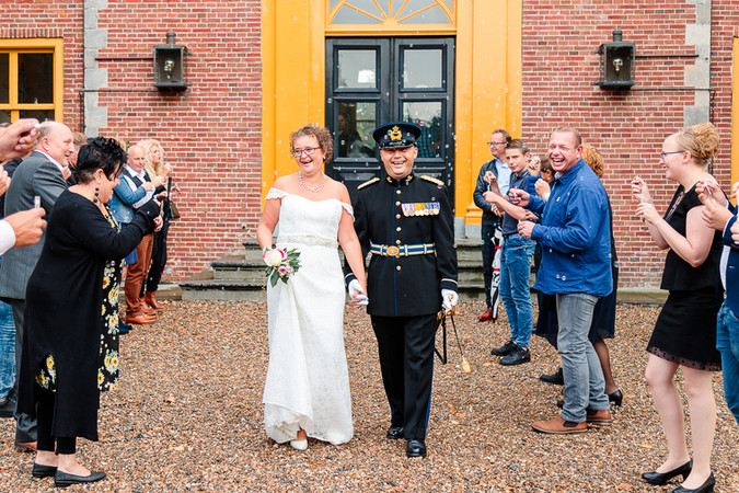 bruidspaar verlaat de trouwlocatie als getrouwd stel