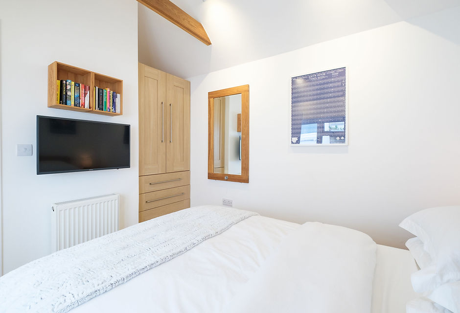 The Boathouse Kingsbridge bedroom with wardrobe and smart TV