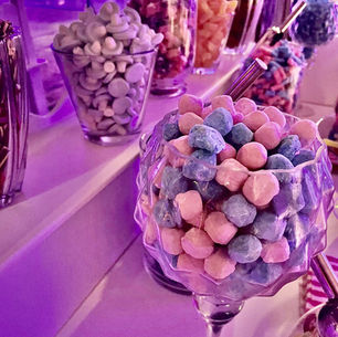 Elegant dessert table setup at a UK wedding with coordinated décor, neutral tones and styled sweet displays.