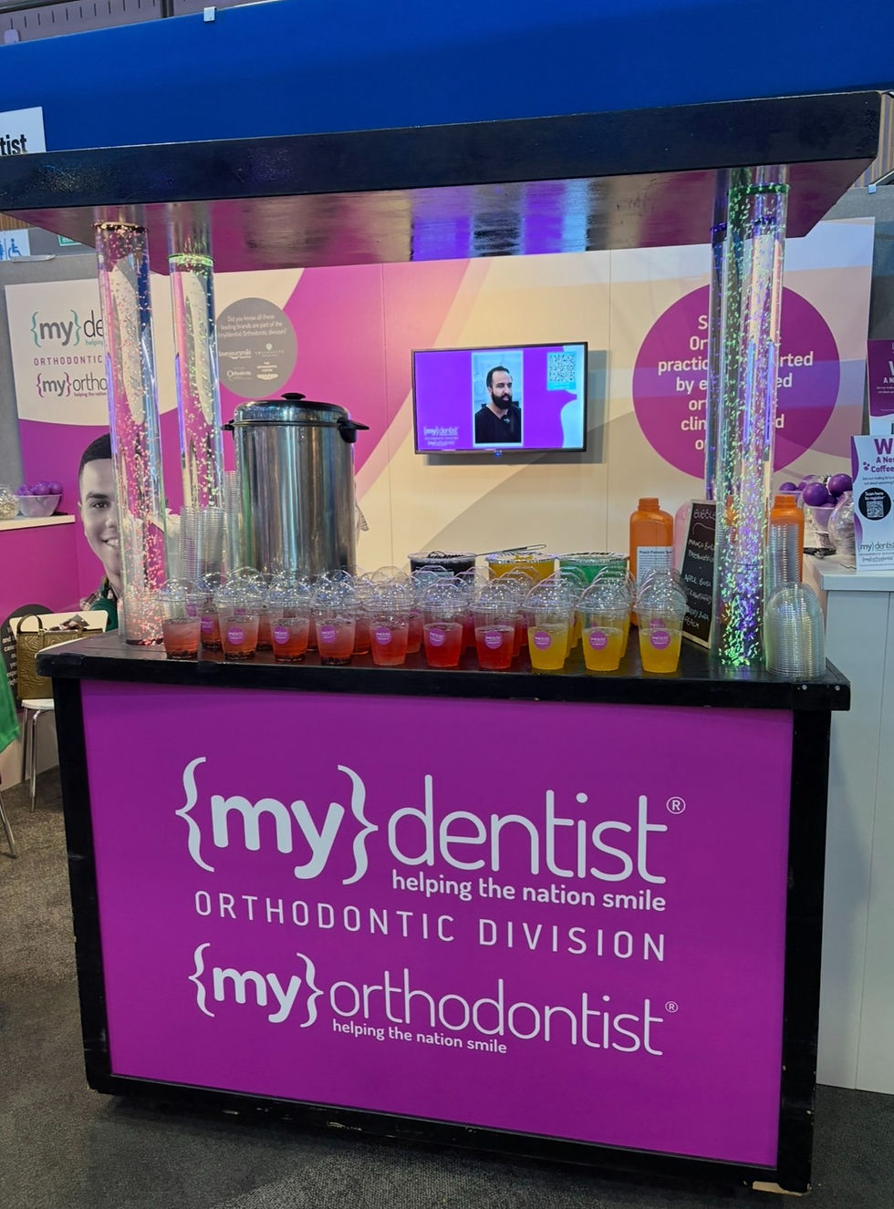 Elegant bubble tea station styled with subtle corporate branding colours creating a cohesive and professional event setup.