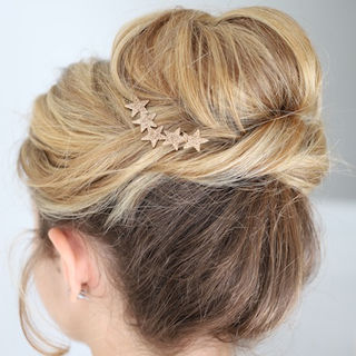 Bride with a high, soft bun styled with jeweled comb