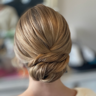 Summer bride with a sleek low bun perfect for a classic and timeless wedding look.