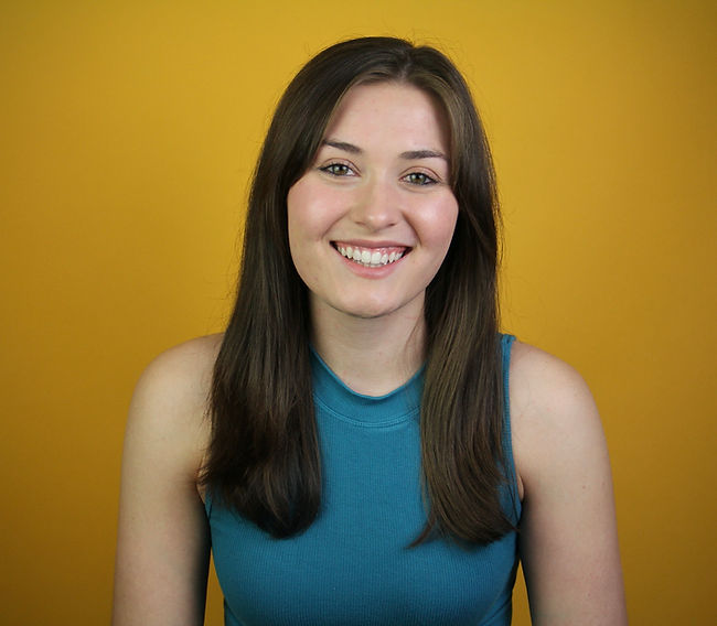 Smiling headshot with yellow background