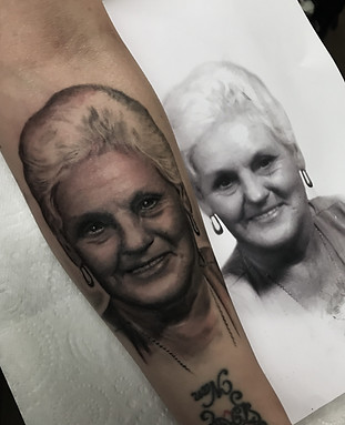 Detailed black and grey elderly woman portrait tattoo by James Brennan
