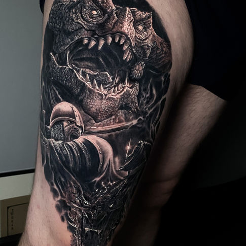 black and grey dragon and knight tattoo by international award winning tattoo artist James Brennan from stag and bones tattoo studio based in Liverpool