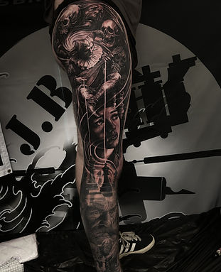 Black and grey conceptual full leg sleeve tattoo by James Brennan