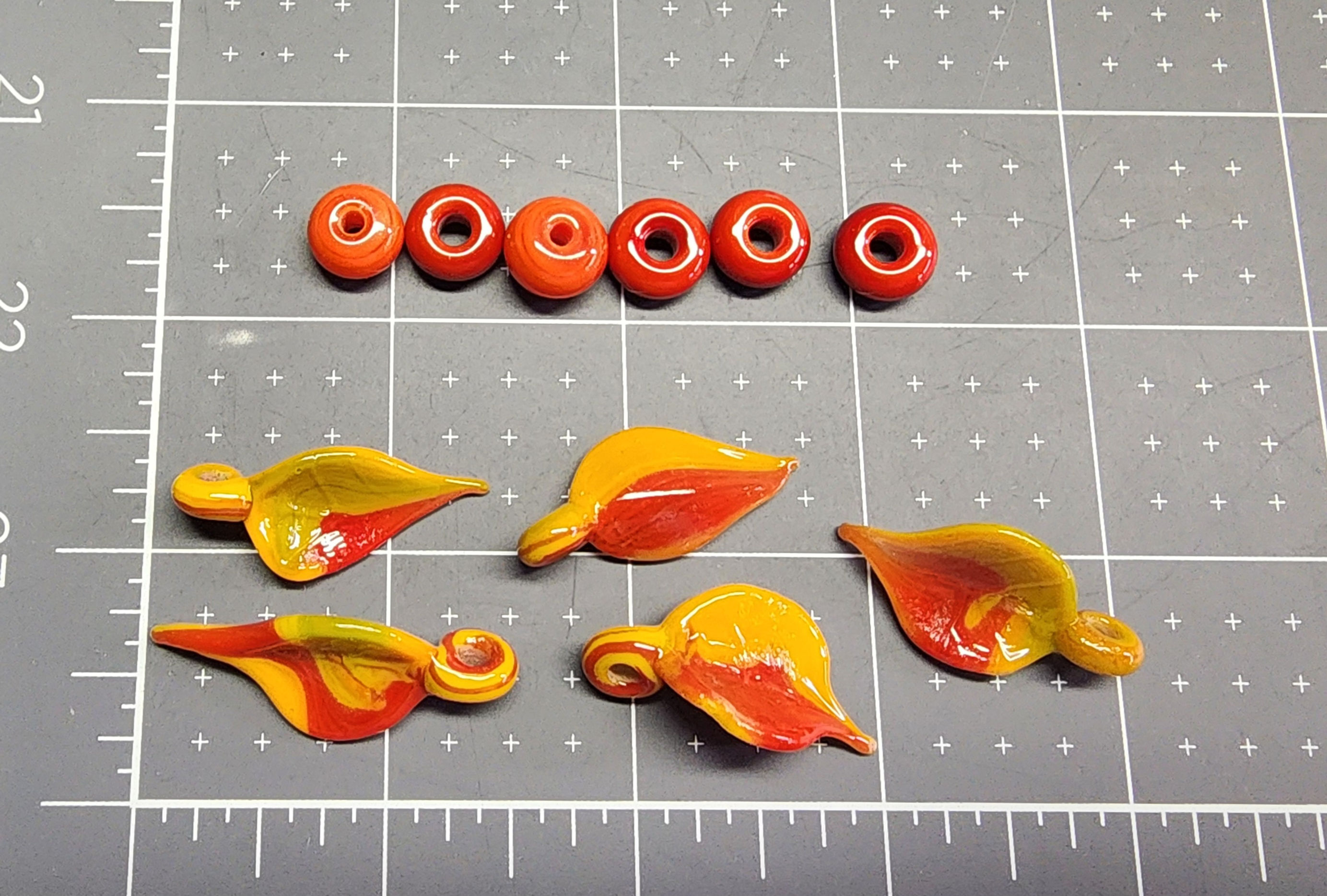 5 Glass leaves and 6 glass beads